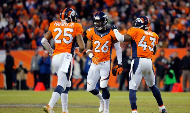 Rahim Moore #26 of the Denver Broncos celebrates an interception with Chris Harris #25 and T.J. War...