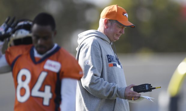 Denver Broncos interim offensive coordinator Bill Musgrave looks at a sheet of paper during practic...