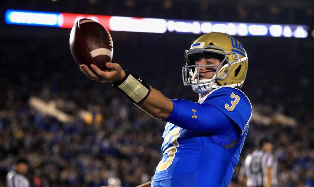 Josh Rosen #3 of the UCLA Bruins tosses the ball after scoring a touchdown on a short run during th...