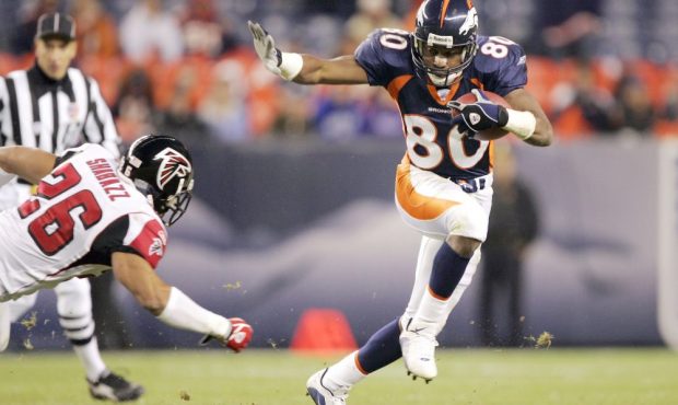 DENVER - OCTOBER 31: Wide receiver Rod Smith #80 of the Denver Broncos slips past safety Siddeeq Sh...