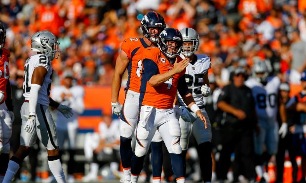Quarterback Case Keenum #4 of the Denver Broncos celebrates a first down after a scramble against t...