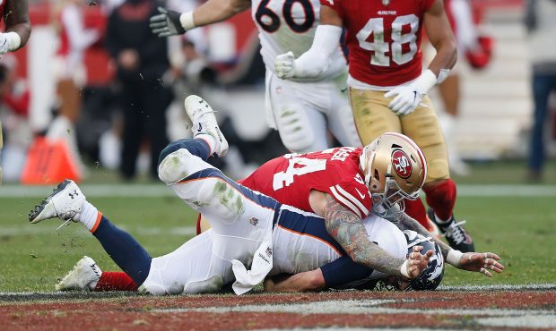 Quarterback Case Keenum #4 of the Denver Broncos is tackled by Cassius Marsh #54 of the San Francis...