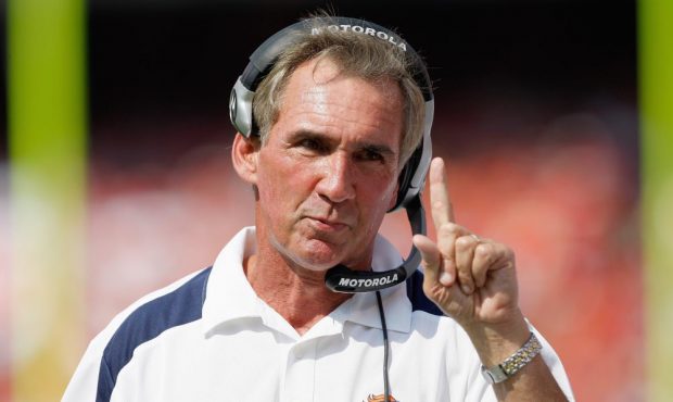 Mike Shanahan of the Denver Broncos motions on the field during the game against the Kansas City Ch...