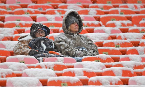 KANSAS CITY, MO - DECEMBER 15: A few fans sit in the snow covered stands before a game between the ...