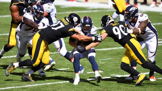 PITTSBURGH, PA - SEPTEMBER 20: Jeff Driskel #9 of the Denver Broncos is sacked by Cameron Heyward #97 and T.J. Watt #90 of the Pittsburgh Steelers during the second quarter at Heinz Field on September 20, 2020 in Pittsburgh, Pennsylvania. (Photo by Joe Sargent/Getty Images)