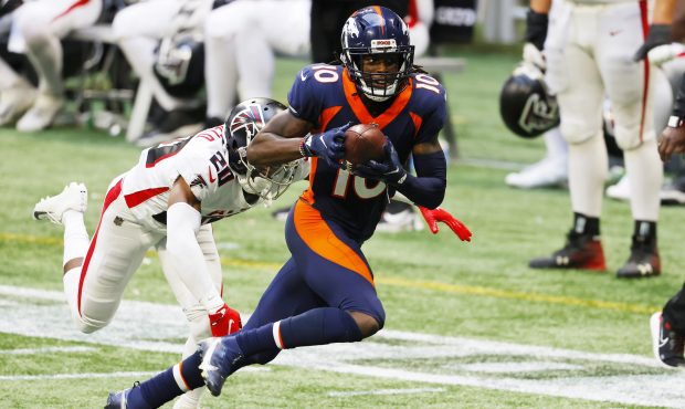 Jerry Jeudy #10 of the Denver Broncos makes a reception against Kendall Sheffield #20 of the Atlant...