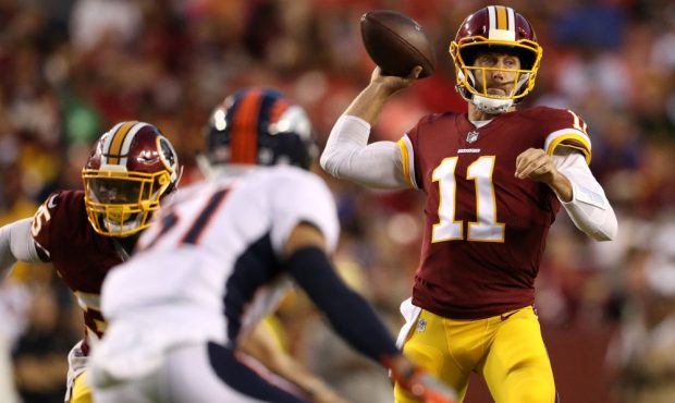 LANDOVER, MD - AUGUST 24: Quarterback Alex Smith #11 of the Washington Redskins looks to pass again...