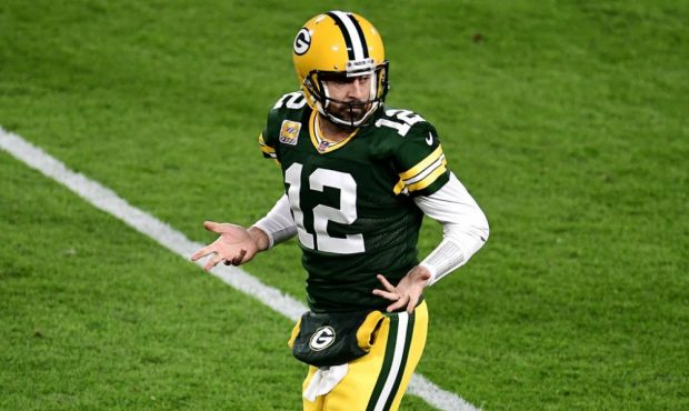 GREEN BAY, WISCONSIN - OCTOBER 05: Aaron Rodgers #12 of the Green Bay Packers reacts after throwing...