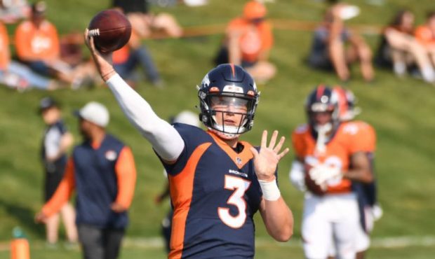 DENVER, COLORADO - AUGUST 17: Denver Broncos quarterback Drew Lock (3) works on passing drills duri...