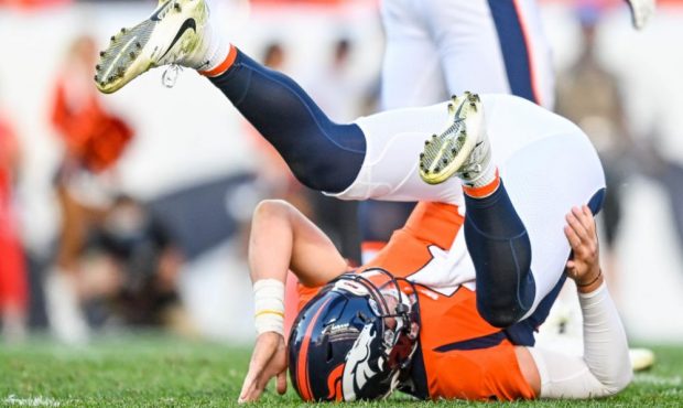 DENVER, CO - OCTOBER 3: Drew Lock #3 of the Denver Broncos rolls backwards after being hit on a pla...