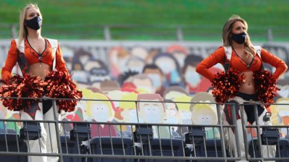 DENVER, COLORADO - SEPTEMBER 27: Denver Broncos cheerleaders wear masks as the perform in the stand...