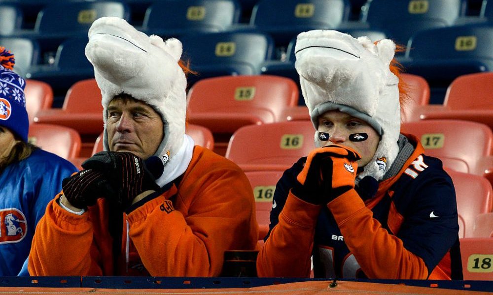 DENVER, CO - DECEMBER 13: Denver Broncos fans sit dejected after losing to the Oakland Raiders 15-1...